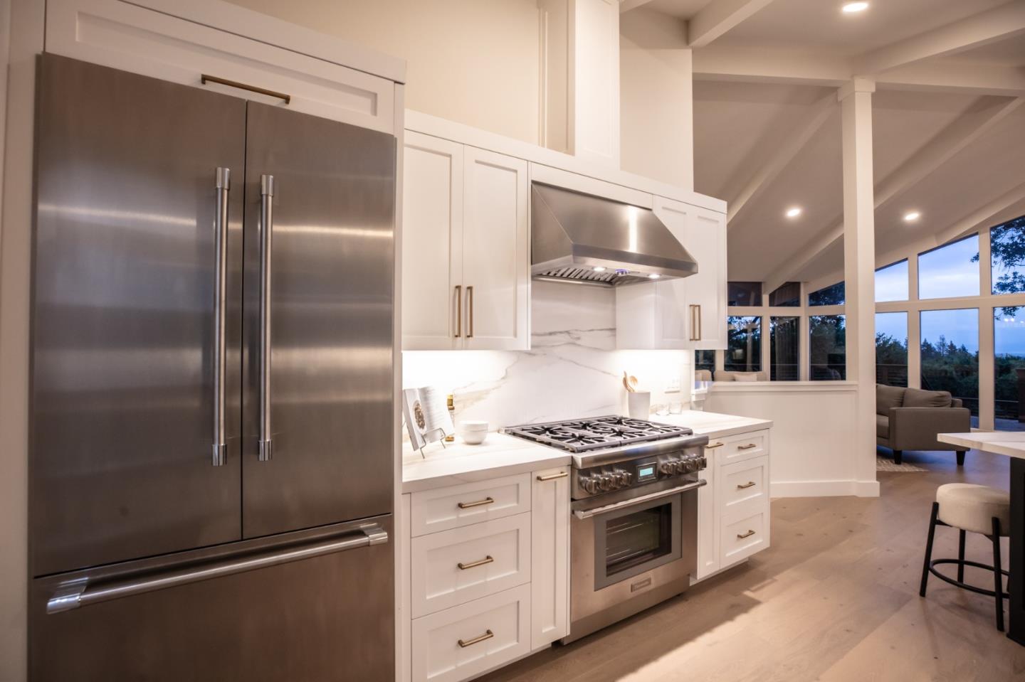 250 Hardwick Road Woodside, CA 94062 - Photo 20 of 65 a kitchen with stainless steel appliances a refrigerator a stove and white cabinets with wooden floor