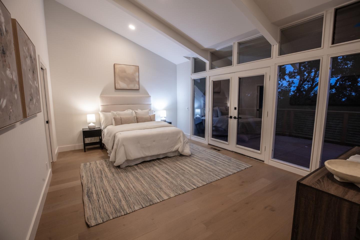 250 Hardwick Road Woodside, CA 94062 - Photo 36 of 65 a bedroom with a large bed and a chandelier