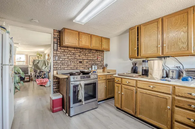 a kitchen with stainless steel appliances granite countertop a stove and a sink