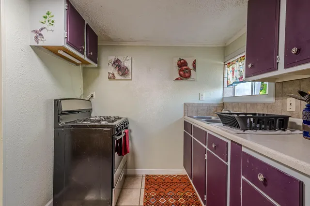 a kitchen with granite countertop a refrigerator and a stove