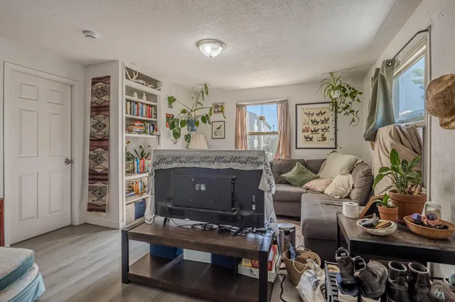 a living room with furniture a flat screen tv and a fireplace