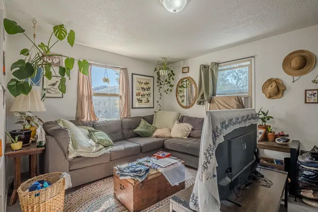 a living room with patio furniture and a window