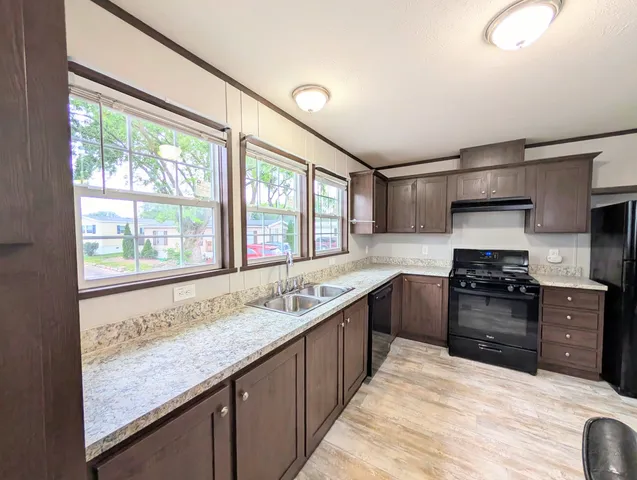 a kitchen with stainless steel appliances granite countertop a sink and stove