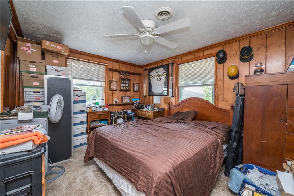 776 Mounts Road Washington, PA 15301 - Photo 19 of 40 a bedroom with a bed and a chandelier