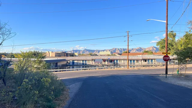 a view of a hallway with wooden floor and a workspace