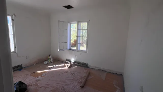 a view of a hallway with wooden floor and a workspace
