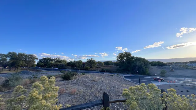a view of a yard with wooden fence