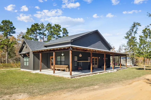 a view of a house with a backyard porch and garden