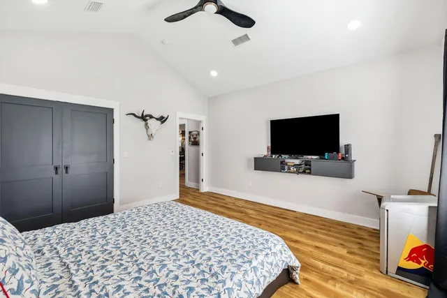 a bedroom with a bed and a flat screen tv