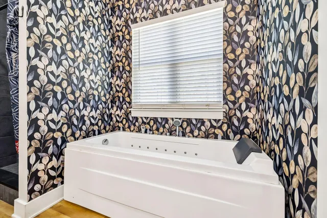 a bathroom with a bathtub and shower