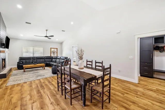 a view of a dining room with furniture and wooden floor