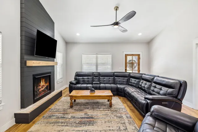 a living room with furniture and a fireplace