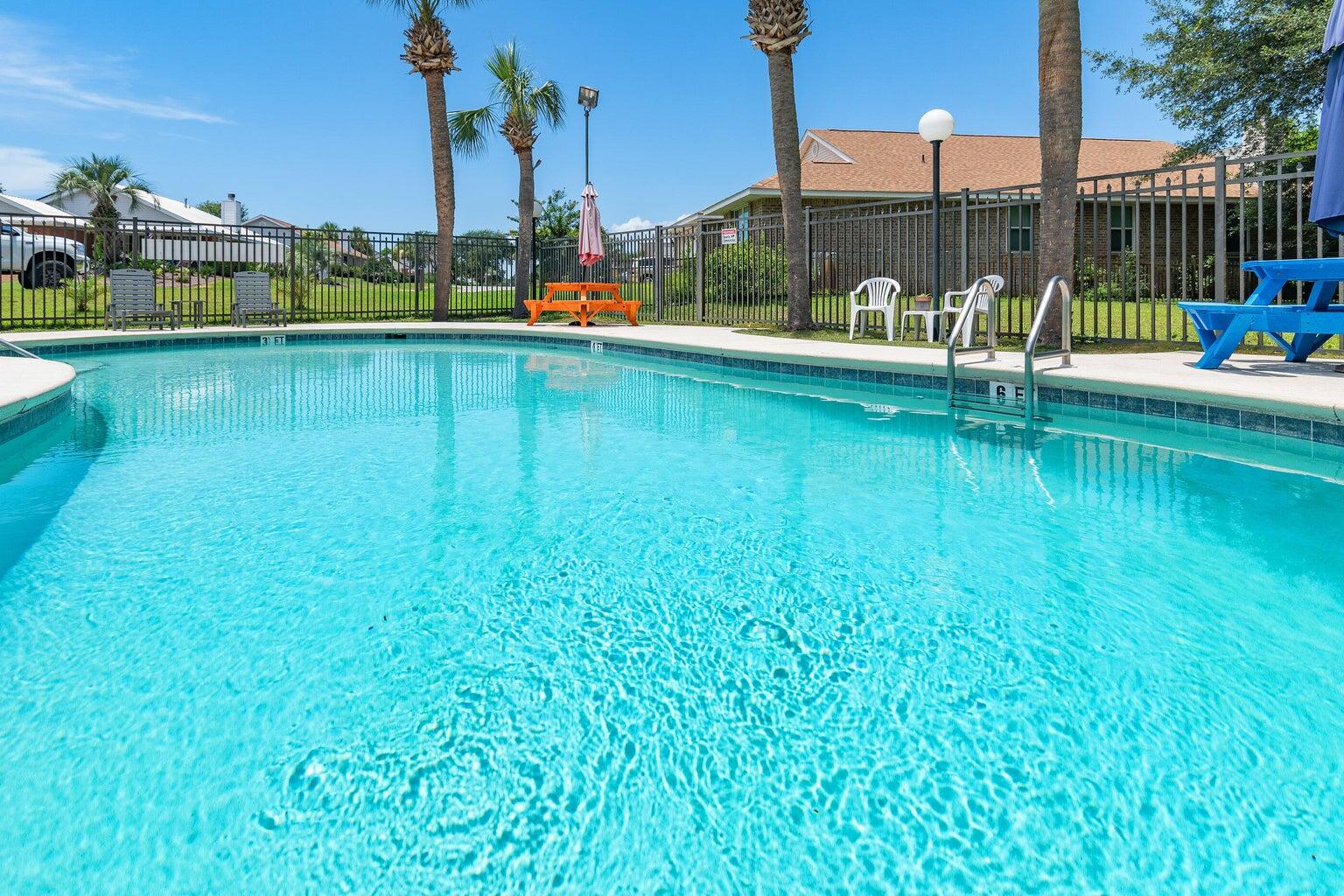 4666 Sunsail Circle Destin, FL 32541 - Photo 13 of 41 a view of a swimming pool with a garden and lake view