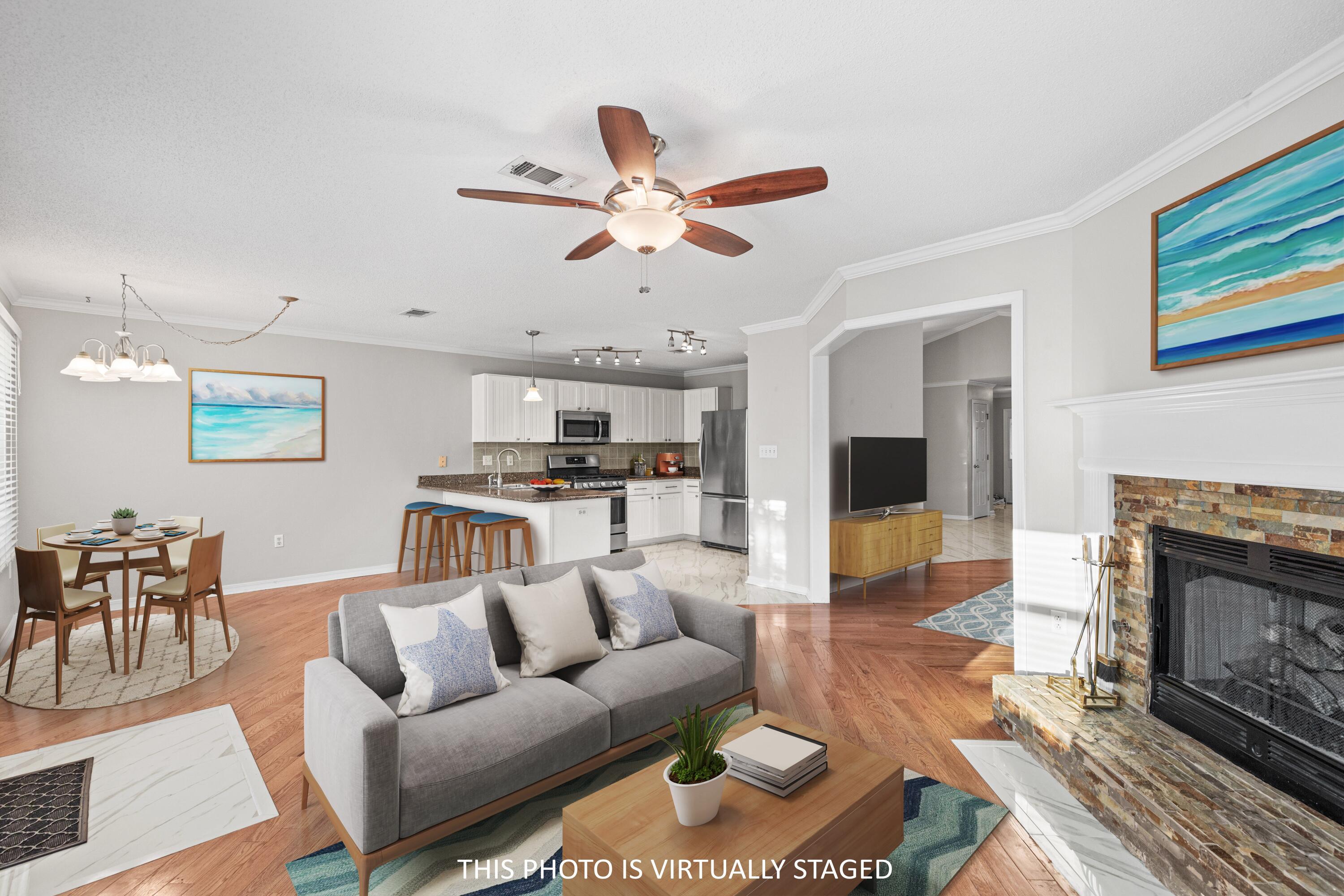 4666 Sunsail Circle Destin, FL 32541 - Photo 26 of 41 a living room with furniture kitchen view and a fireplace