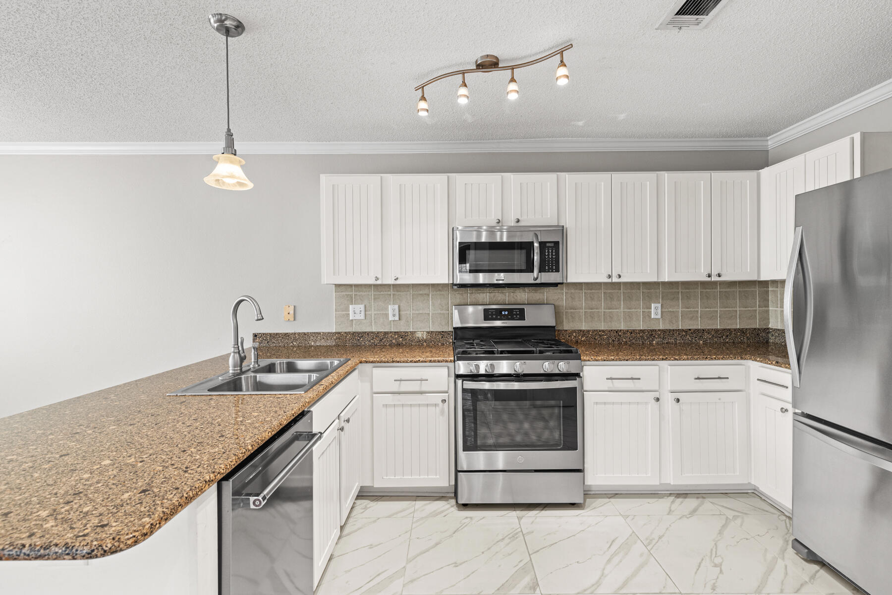 4666 Sunsail Circle Destin, FL 32541 - Photo 30 of 41 a kitchen with stainless steel appliances granite countertop a sink a stove a refrigerator and white cabinets
