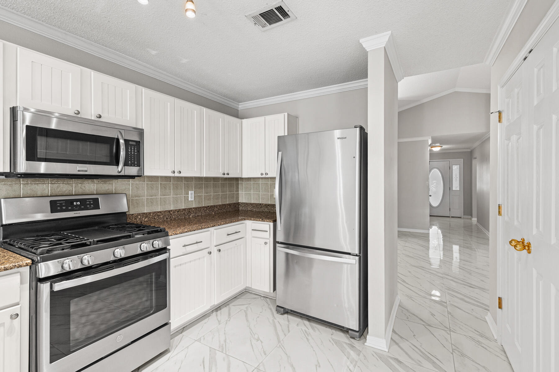 4666 Sunsail Circle Destin, FL 32541 - Photo 31 of 41 a kitchen with a refrigerator stove and white cabinets