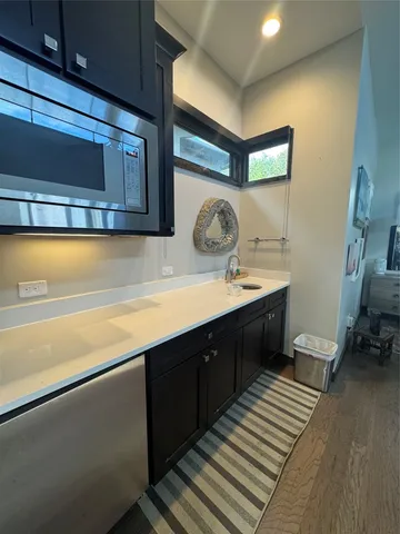 a living room with stainless steel appliances kitchen island granite countertop furniture and a view of kitchen