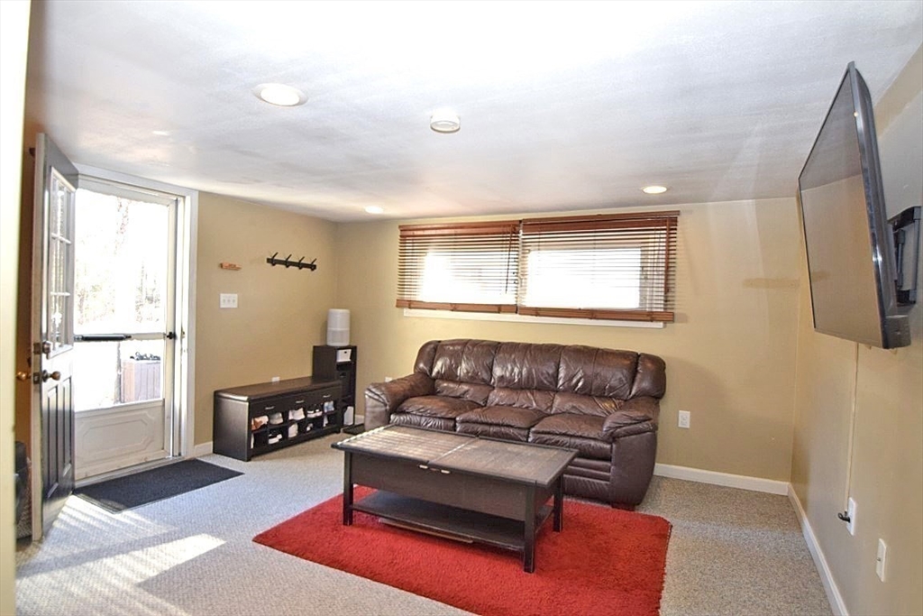 17 Kalmia Road Holbrook, MA 02343 - Photo 12 of 27 a living room with furniture and a flat screen tv