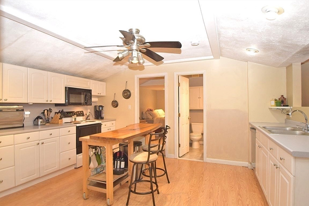 17 Kalmia Road Holbrook, MA 02343 - Photo 6 of 27 a kitchen with stainless steel appliances kitchen island granite countertop a sink and cabinets