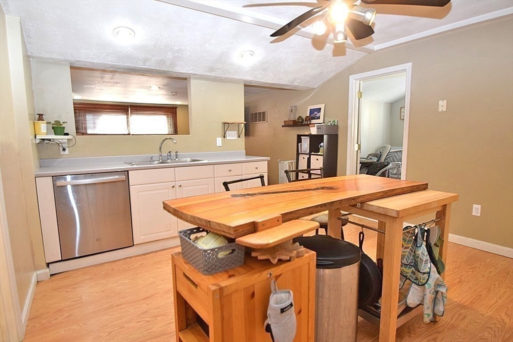 17 Kalmia Road Holbrook, MA 02343 - Photo 7 of 27 a dining table with chairs and cabinets
