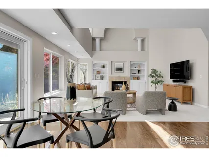 a living room with furniture a flat screen tv and kitchen view