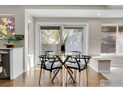 a view of a dining room with furniture and a potted plant