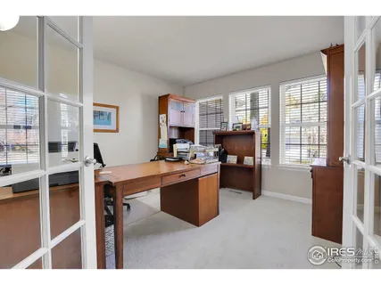 a living room with furniture a large window and kitchen