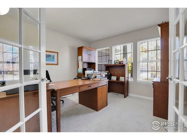 a living room with furniture a large window and kitchen