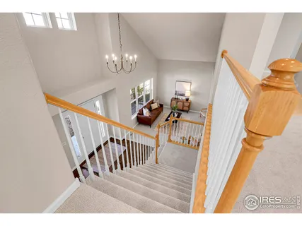 a view of a livingroom with furniture stairs and bedroom view
