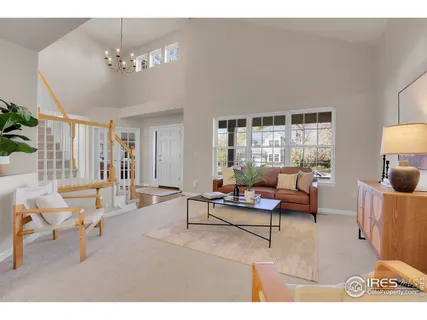 a living room with furniture and a chandelier