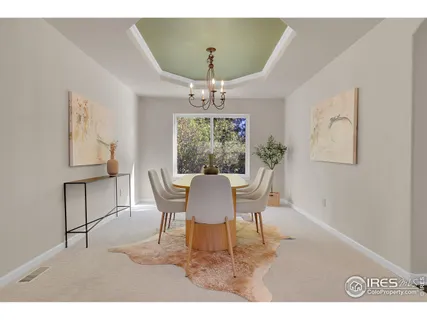 a dining room with furniture a rug and a chandelier