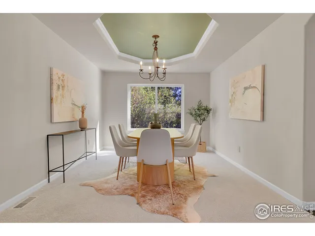a dining room with furniture a rug and a chandelier