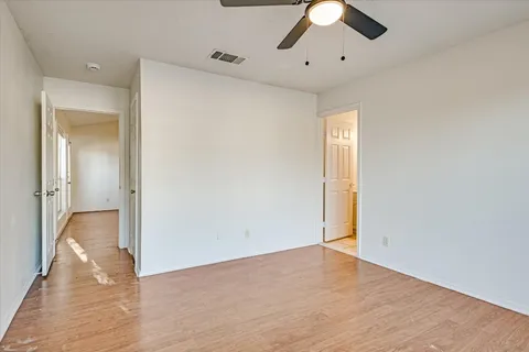 a bathroom with a toilet sink vanity and mirror