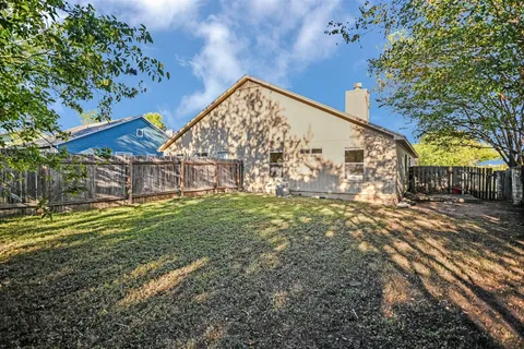 a view of a backyard with large trees