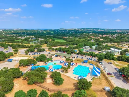 a view of a swimming pool and trees in the background