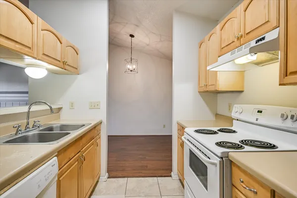 a kitchen with stainless steel appliances a stove a sink and a refrigerator