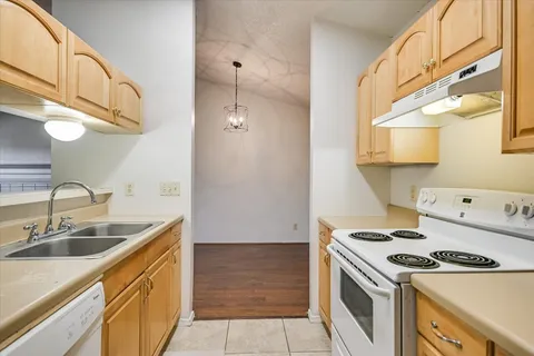 a kitchen with stainless steel appliances a stove a sink and a refrigerator
