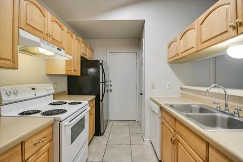 a view of empty room with wooden floor and windows