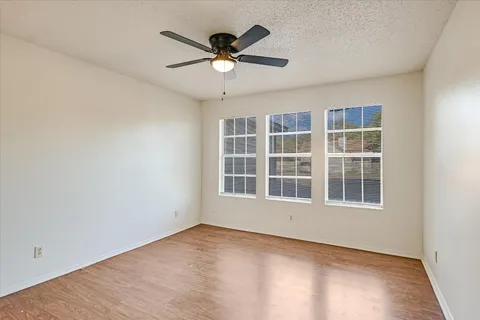 an empty room with closet and chandelier fan