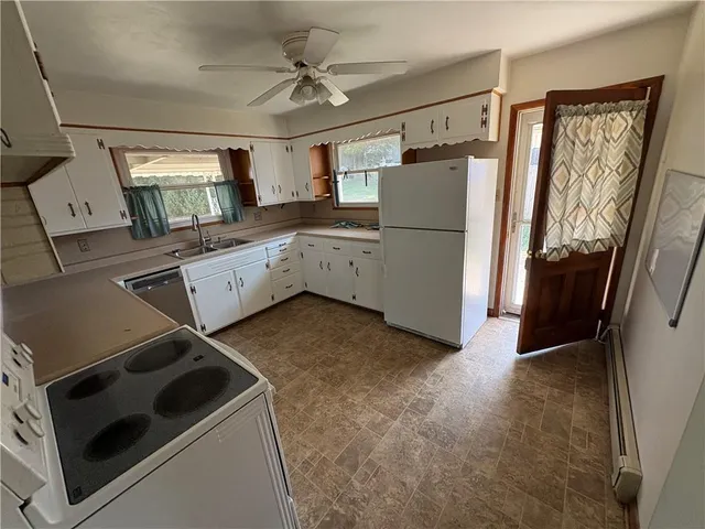 a kitchen with refrigerator and window