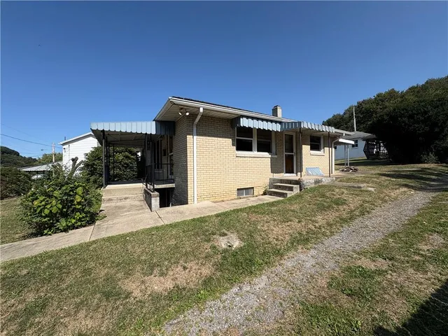 a view of a house with swimming pool and sitting area