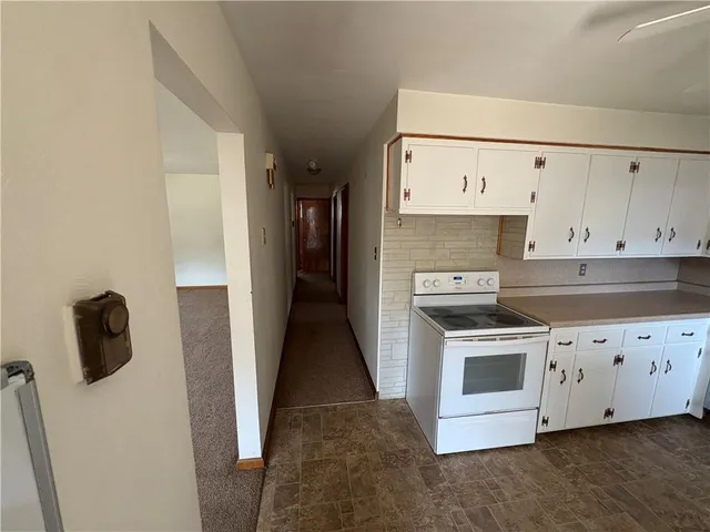 a kitchen with granite countertop a stove and a refrigerator