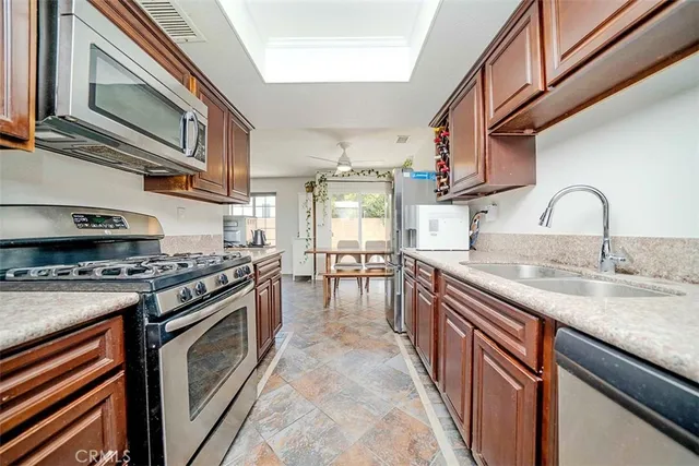 a kitchen with stainless steel appliances granite countertop a stove and a sink