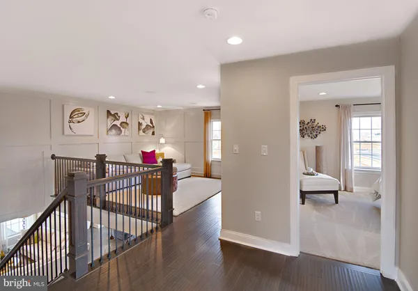 a view of a livingroom with wooden floor and furniture