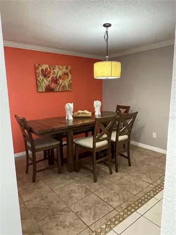 a dining room with a table and chairs