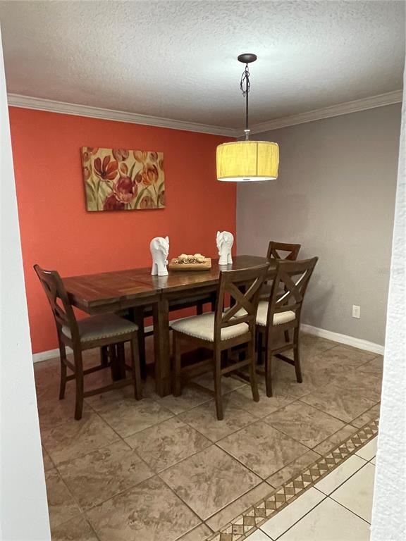 879 Little Bend Road Altamonte Springs, FL 32714 - Photo 7 of 23 a dining room with a table and chairs