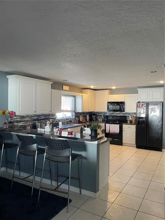 879 Little Bend Road Altamonte Springs, FL 32714 - Photo 10 of 23 a kitchen with a table chairs stove and cabinets