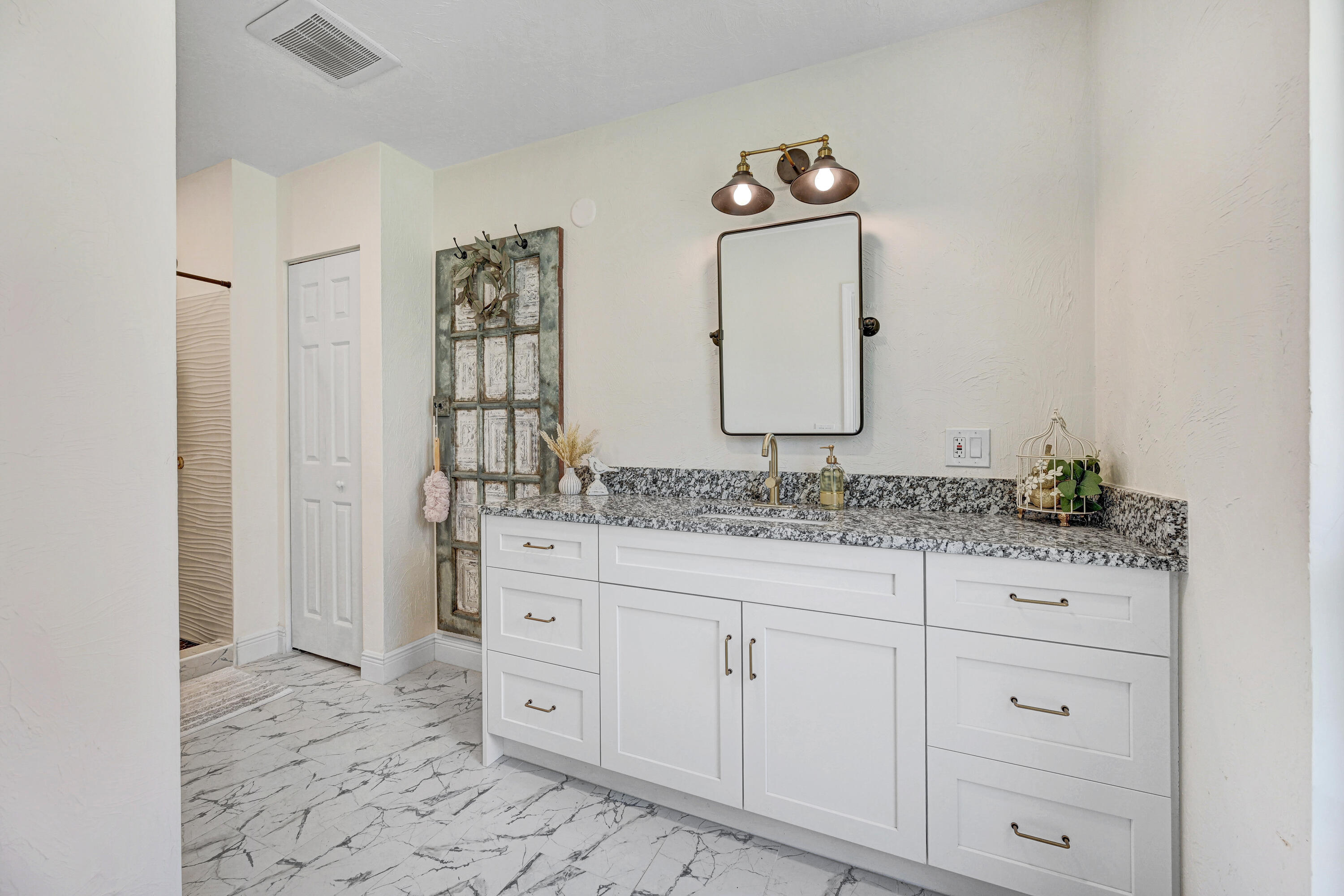 2340 Turtle Mound Road Melbourne, FL 32934 - Photo 11 of 30 a bathroom with a granite countertop sink and a mirror