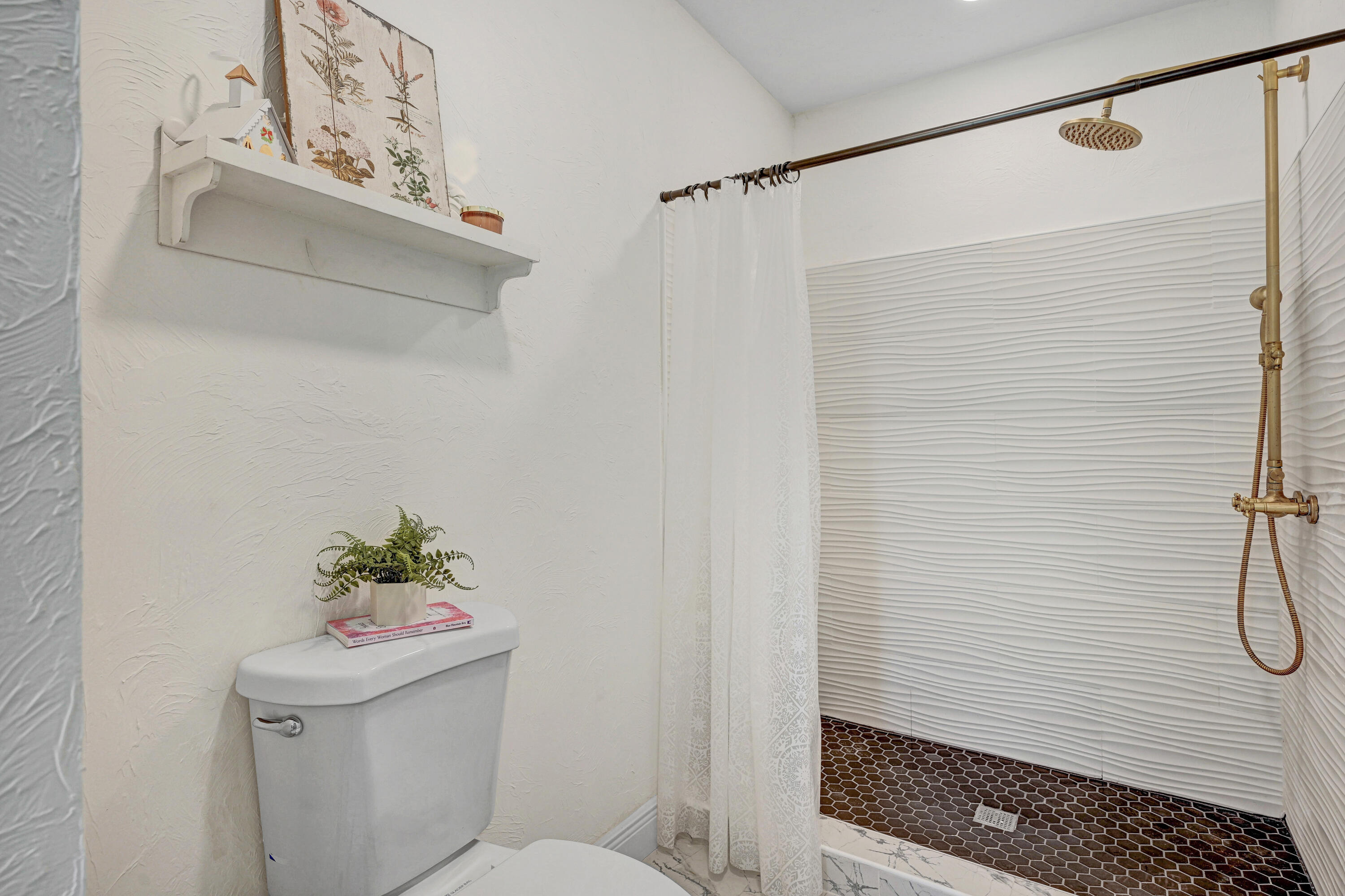 2340 Turtle Mound Road Melbourne, FL 32934 - Photo 12 of 30 a bathroom with a sink a toilet and shower