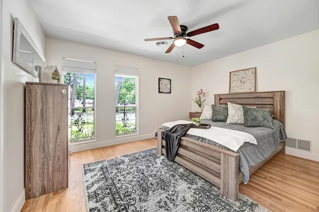 a bedroom with a large bed and a window